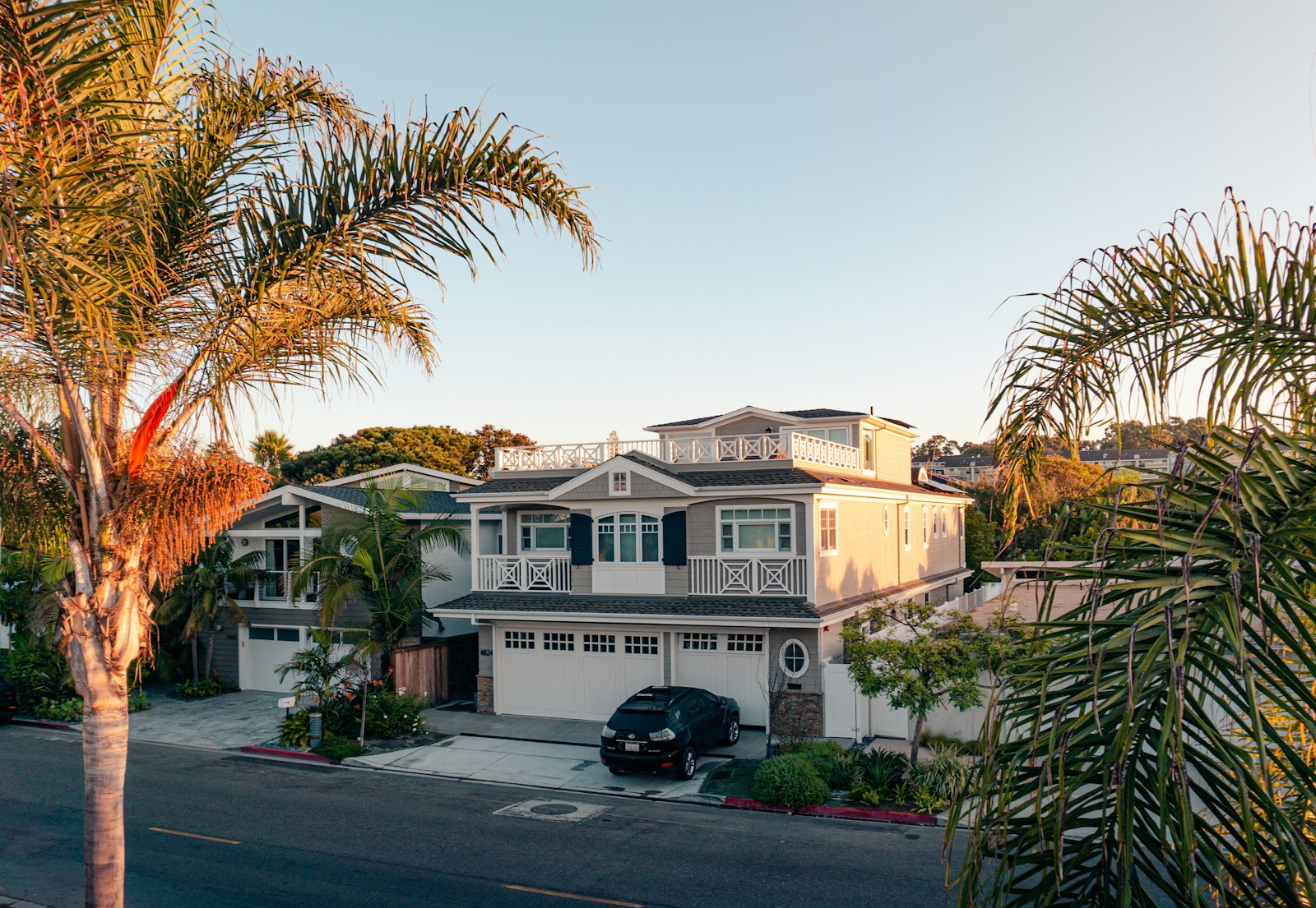green trees near white 2-story house